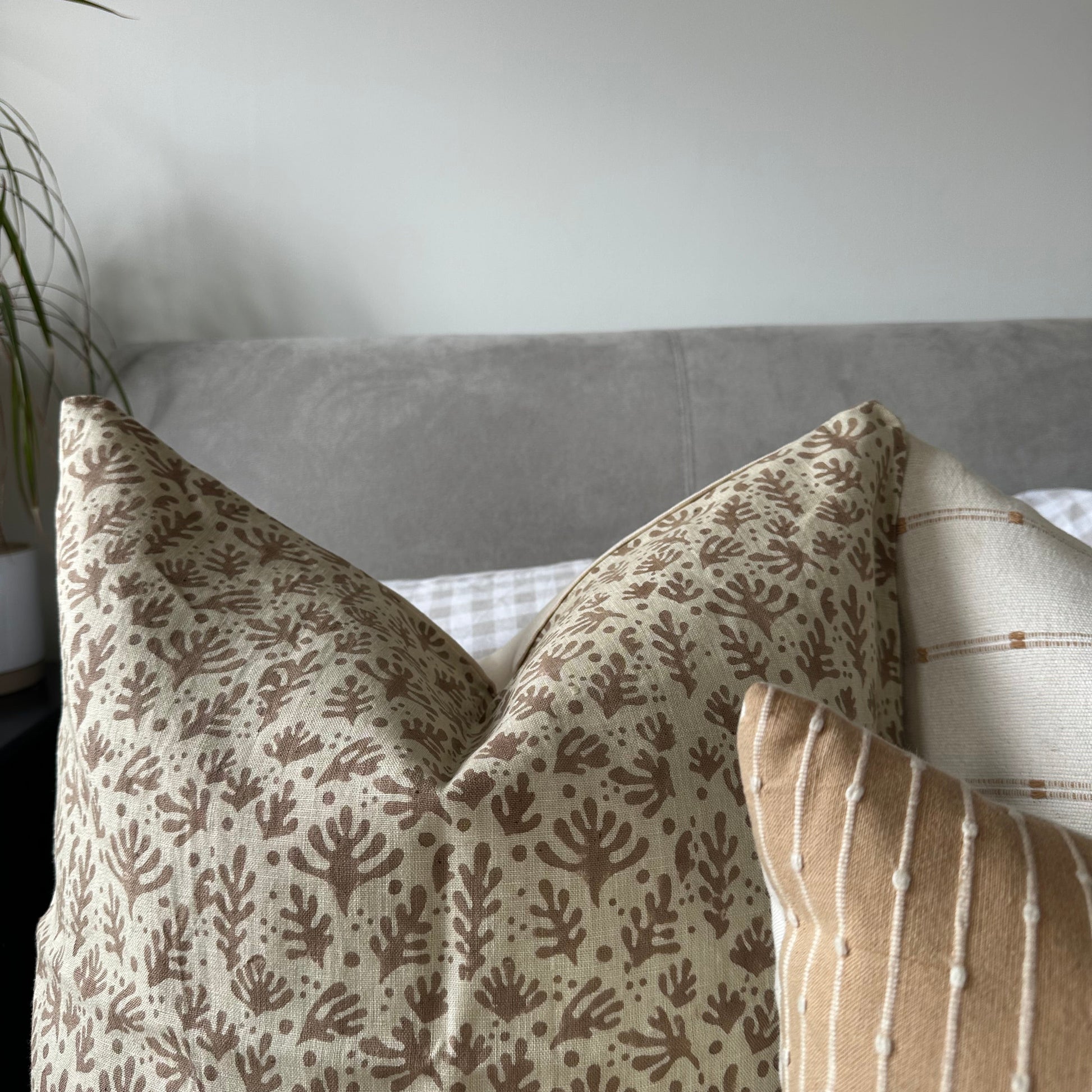 Textured fabric cushion with leaf pattern 